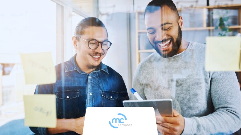 Two coworkers using Jamf Protect on a handheld device.